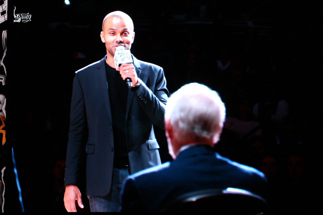 Tony Parker talks to Gregg Popovich, who coached him when he played for the San Antonio Spurs, at a ceremony where Parker's No. 9 Jersey was retired.